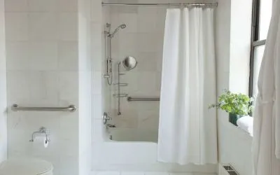 Guest bathroom in The Benjamin Royal Sonesta New York, featuring bath, shower, lavatory, and a small potted plant.