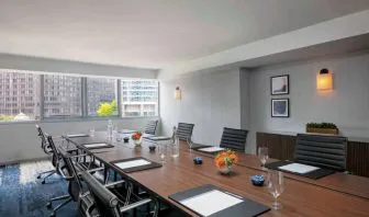 Royal Sonesta Chicago Downtown meeting room, including long table and swivel chairs, with views of the urban landscape.