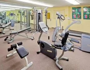 Sonesta Simply Suites Parsippany Morris Plains’ fitness center is equipped with assorted exercise machines, a mirrored wall, and a TV.
