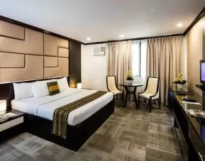 King room with chairs and work space at Apo View Hotel.
