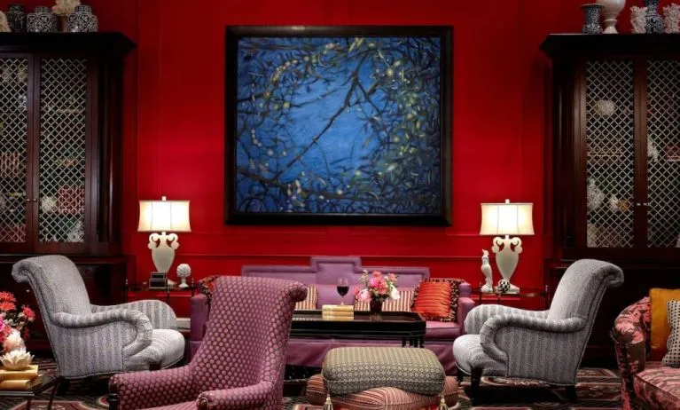 The lobby lounge in Royal Sonesta Portland Downtown is furnished with comfortable armchair and sofa seating, coffee tables, and art on the wall.