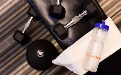The fitness center at Sonesta Simply Suites Plano Frisco includes free weights and benches for guests to use, plus towels and water.
