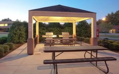 The gazebo at Sonesta Simply Suites Dallas Las Colinas includes barbecue facilities and picnic tables and benches where guests can dine and socialize.