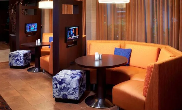 The media pods at Sonesta Select Detroit Auburn Hills are cozy nooks, with each featuring comfy seating, a coffee table, and a TV.