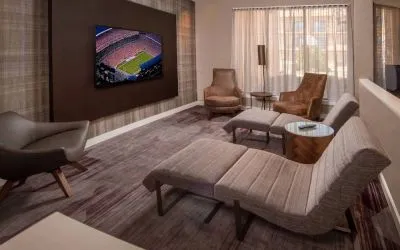 The hotel’s lobby features reclined seats facing a large, wall-mounted TV.