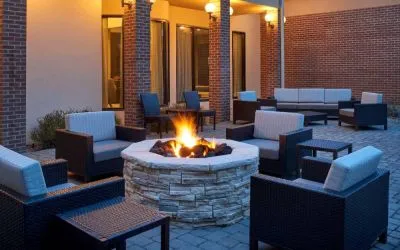 Sonesta Select Indianapolis Carmel’s patio features a fire pit and armchairs, plus coffee tables and sofa seating.