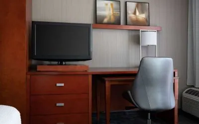 Sonesta Select Phoenix Camelback guest room workspace, including desk, chair, and lamp, plus a TV.