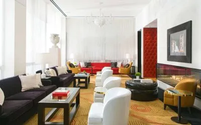 The lounge in Royal Sonesta Chicago River North has comfy chairs and numerous sofas, coffee tables, and large windows creating plenty of natural light.