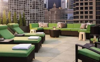 Royal Sonesta Chicago River North’s patio is furnished with chairs, loungers, and sofas, and offers city views.