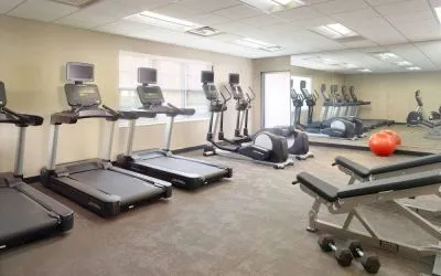Sonesta ES Suites Raleigh Durham Airport Morrisville’s fitness center is equipped with free weights, benches, and various exercise machines.