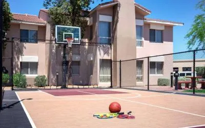 The hotel basketball court has fencing by the hoop, and can also be used for playing tennis.