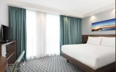 King room with TV and work station at Hampton By Hilton London Stansted Airport.