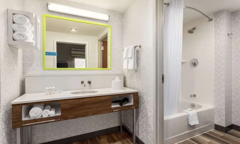 Guest bathroom with shower at Hampton Inn & Suites Miami Kendall. 