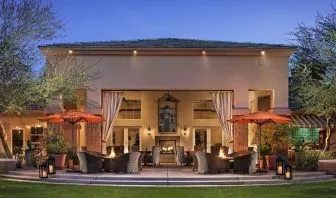 Hotel exterior with outdoor seating at Sonesta Suites Scottsdale Gainey Ranch.