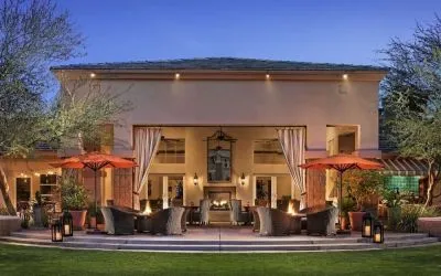 Hotel exterior with outdoor seating at Sonesta Suites Scottsdale Gainey Ranch.