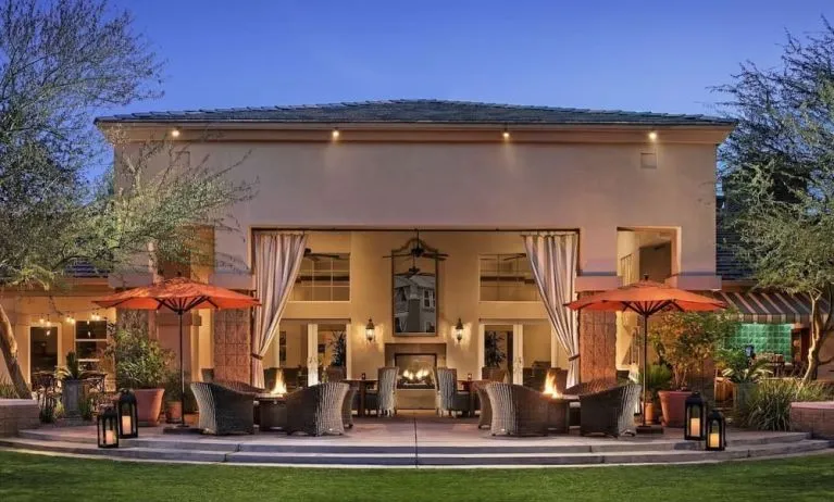 Hotel exterior with outdoor seating at Sonesta Suites Scottsdale Gainey Ranch.