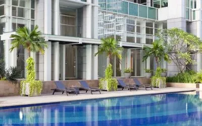 Hotel pool with pool chairs at Fraser Residence Sudirman Jakarta.
