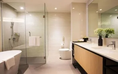 Guest bathroom with bath and shower at Modena By Fraser Bangkok.