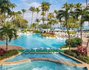 Outdoor pool with palm trees at Royal Sonesta San Juan.