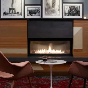 Cozy lounge with fire place at The Fifty Sonesta Select New York.