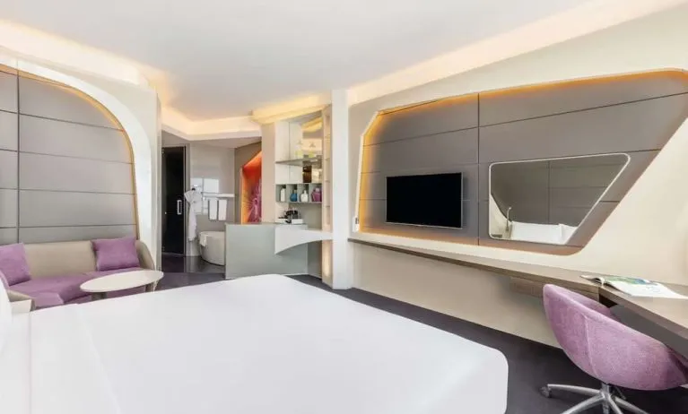 Well-lit king room at V Hotel Dubai.