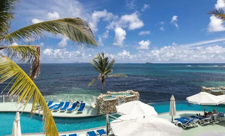 Relaxing outdoor pool and ocean view at Oyster Bay Beach Resort.