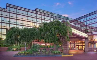 Hotel exterior and parking at Laguardia Plaza Hotel.