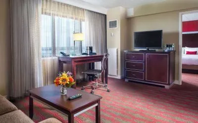 Spacious king room with lounge area at Laguardia Plaza Hotel.