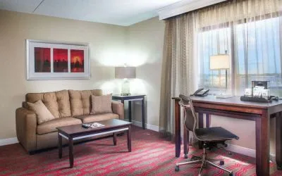 King room with lounge and work desk at Laguardia Plaza Hotel.