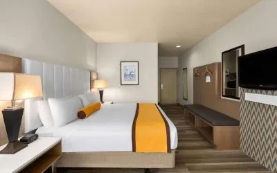 King bed with TV at Hotel Marguerite.