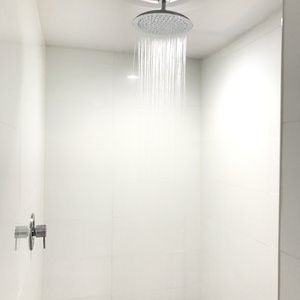 Guest bathroom with shower at Ramsey Inn & Suites.