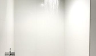 Guest bathroom with shower at Ramsey Inn & Suites.