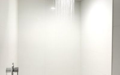 Guest bathroom with shower at Ramsey Inn & Suites.