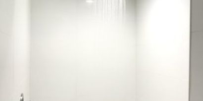 Guest bathroom with shower at Ramsey Inn & Suites.