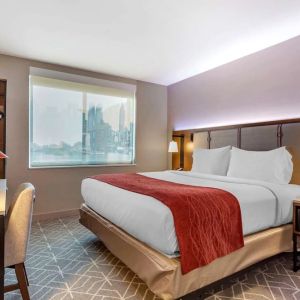 Day use room with work desk and natural light at Comfort Inn JFK Airport.