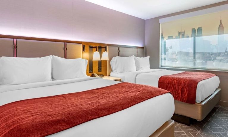 Twin bedroom with natural light at Comfort Inn JFK Airport.