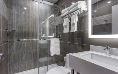 Guest bathroom with shower at Comfort Inn JFK Airport.