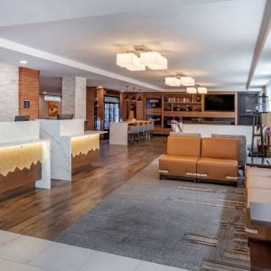 Lobby and coworking lounge at Comfort Inn JFK Airport.