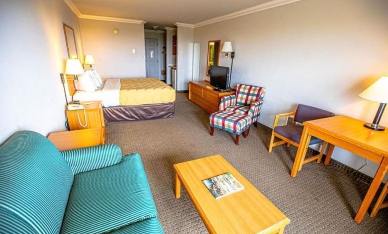Spacious king room with TV and lounge area at Coratel Inn And Suites By Jasper Ocean Shores.