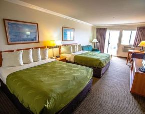 Two queen beds at Coratel Inn And Suites By Jasper Ocean Shores.