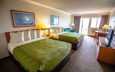 Two queen beds at Coratel Inn And Suites By Jasper Ocean Shores.