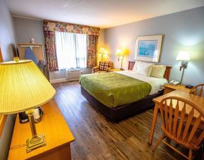 Romantic king room with seating area at Coratel Inn And Suites By Jasper Ocean Shores.