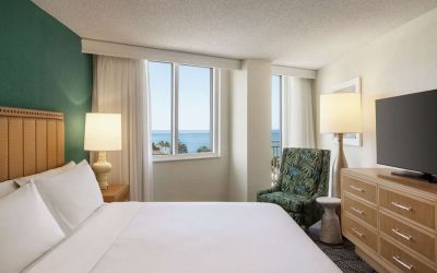 Romantic king room with TV at Embassy Suites By Hilton Deerfield Beach Resort & Spa.