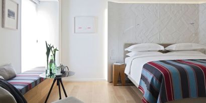Cozy king room with natural light at Mendeli Street Hotel.