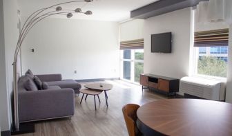 Hotel room with lounge and TV at Aloft Miami Doral.
