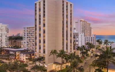 Hotel exterior at sunset at Hyatt Place Waikiki Beach.