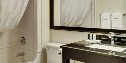 Guest bathroom with shower and tub at Comfort Inn Sherbrooke.