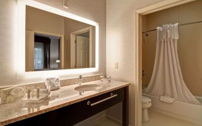 Guest bathroom with shower and tub at Homewood Suites By Hilton Newark-Cranford.
