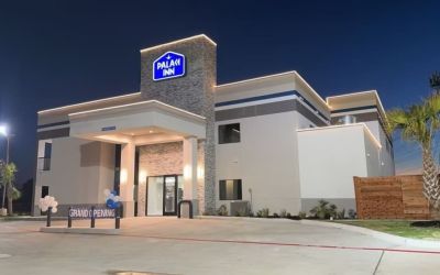 Hotel exterior at night at Palace Inn Blue Jones Rd. 