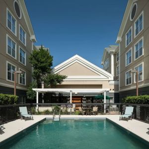 Outdoor pool with sun loungers at Homewood Suites By Hilton Austin NW Near The Domain.